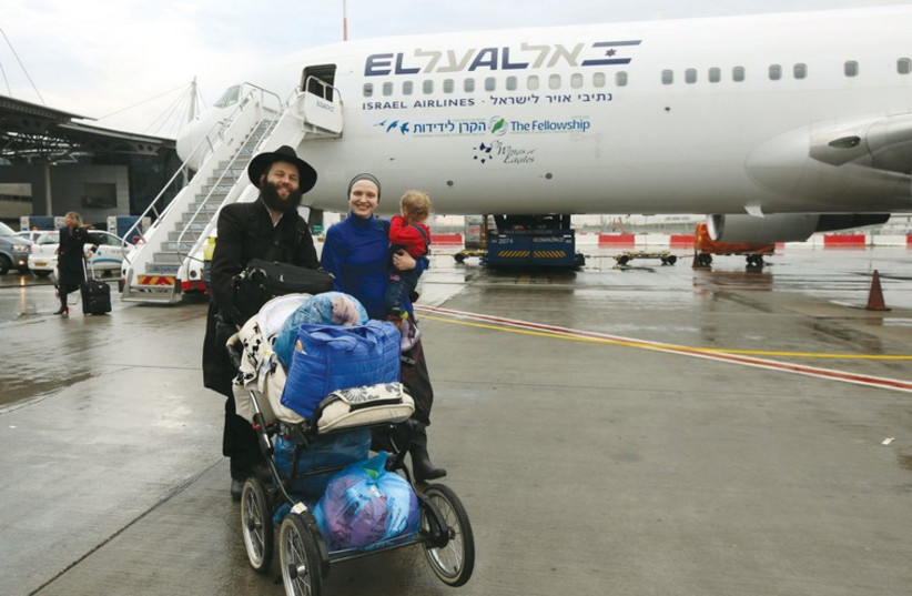 Ukrainian immigrants disembark from a December 22 flight from Kiev (photo credit: COURTESY IFCJ)