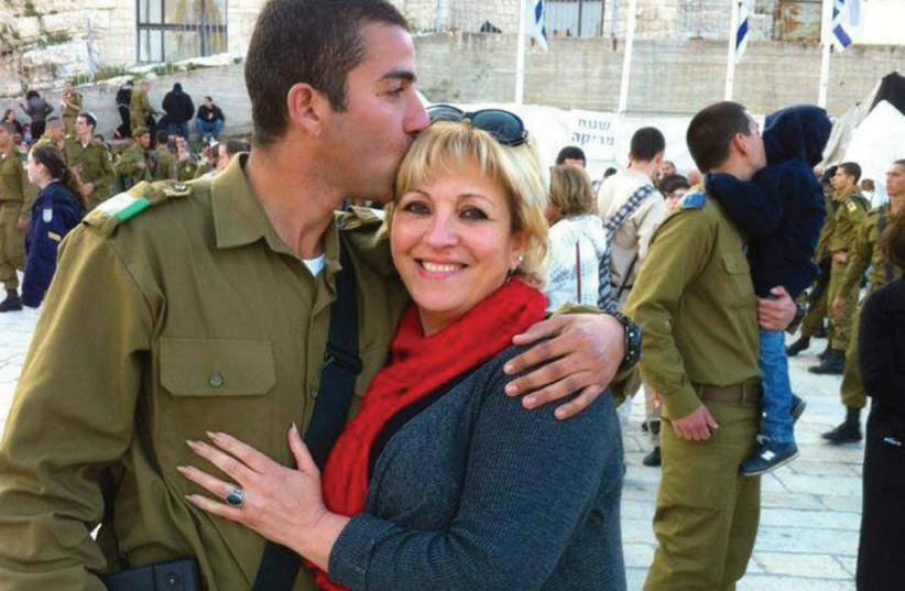 ANETT HASKIA embraces her youngest son, Hussam, at his IDF swearing-in ceremony at the Kotel. 	 (photo credit: Courtesy)