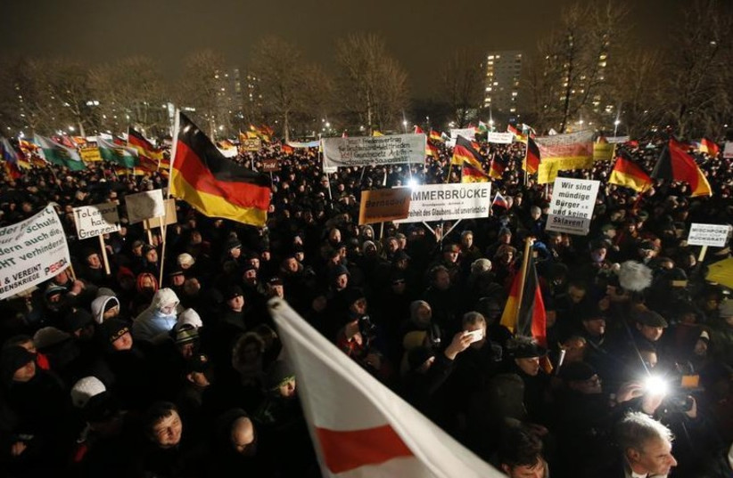 Participants take part in a demonstration called by anti-immigration group PEGIDA, a German abbreviation for "Patriotic Europeans against the Islamization of the West", in Dresden (photo credit: REUTERS)