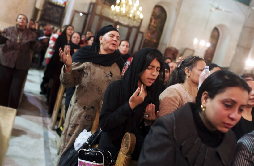 Coptic Orthodox Christian pray during a religious session by father Makary at St Mark Cathedral in Cairo (photo credit: REUTERS)
