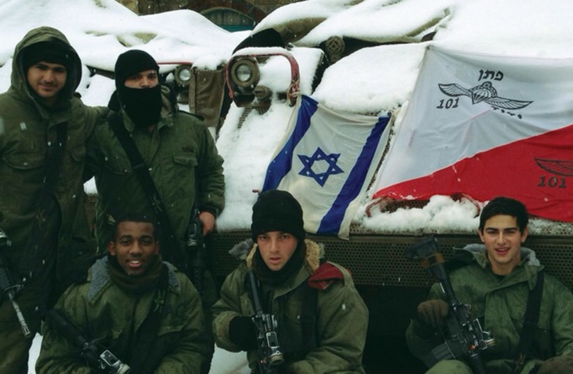 PARATROOPERS STATIONED in Beit Jann, in the Galilee, pose for a photo in the snow yesterday. (photo credit: IDF SPOKESMAN’S UNIT)