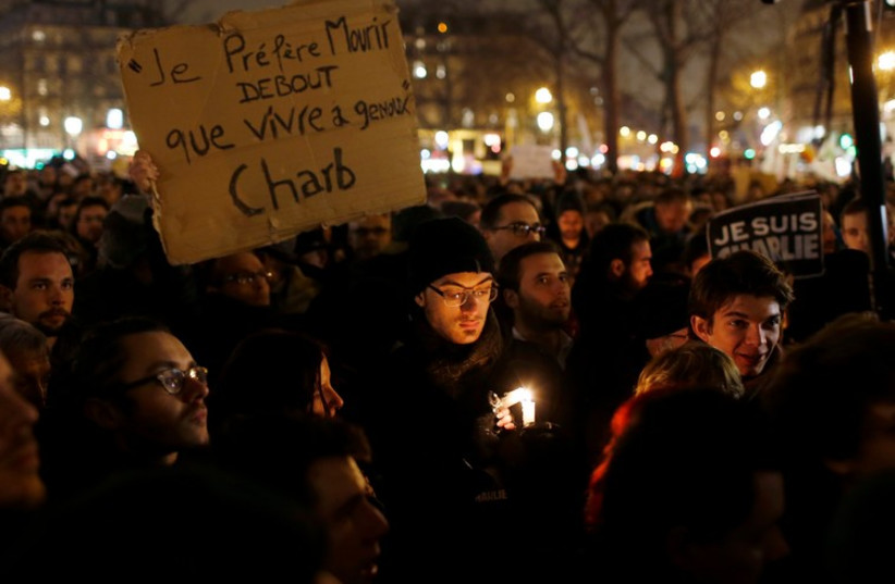 A vigil to pay tribute to the victims of a shooting at Charlie Hebdo in Paris (photo credit: REUTERS)
