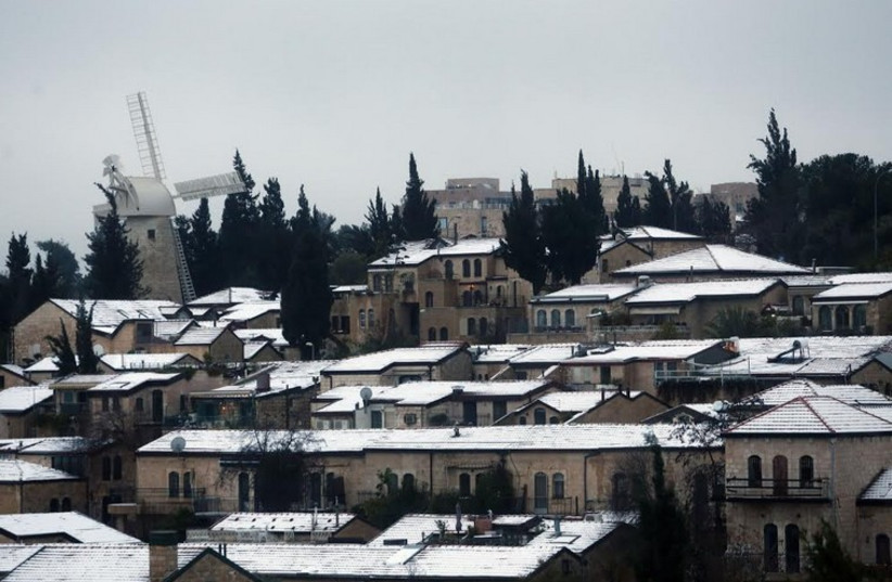 Snow covered rooftops are seen in Jerusalem January 8 (photo credit: MARC ISRAEL SELLEM)