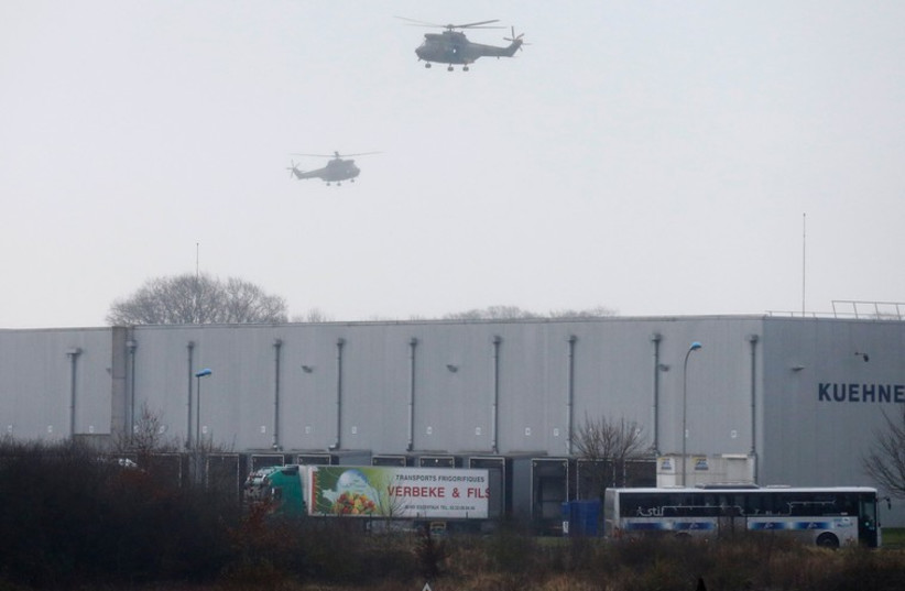 Helicopters with French intervention forces hover above the scene of a hostage taking at an industrial zone in Dammartin-en-Goele, northeast of Paris January 9 (photo credit: REUTERS)