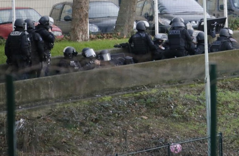 Members of the French police special forces take position near the scene of a hostage taking at a kosher supermarket near the Porte de Vincennes in eastern Paris (photo credit: REUTERS)