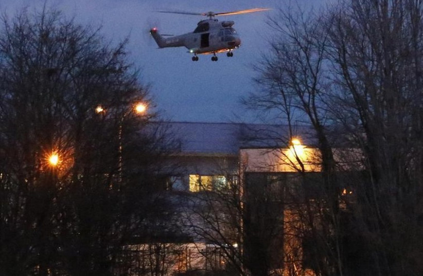A helicopter hovers after the final assault at the scene of a hostage taking at an industrial zone in Dammartin-en-Goele, northeast of Paris (photo credit: REUTERS)
