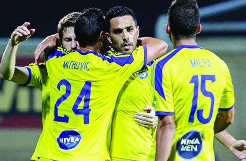 Maccabi TA players celebrating (photo credit: ERAN LUF)