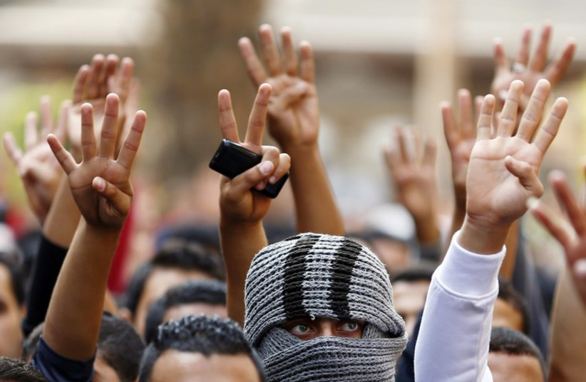 The Rabaa sign is flashed, symbolizing support for the Muslim Brotherhood (photo credit: REUTERS)