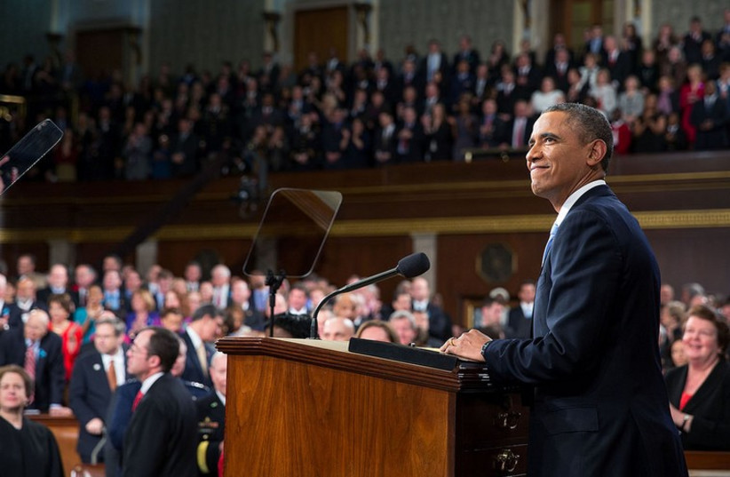President Barack Obama acknowledges applause before he delivers the State of the Union address in the House Chamber at the U.S. Capitol in Washington, D.C., Jan. 28, 2014. (photo credit: OFFICIAL WHITE HOUSE PHOTO / PETE SOUZA)