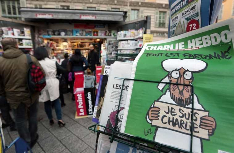 People queue for the new issue of satirical French weekly Charlie Hebdo at a kiosk in Nice. (photo credit: REUTERS)