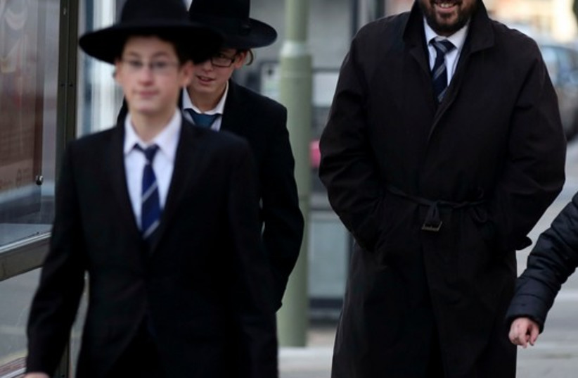 A Jewish man and boys in London (photo credit: REUTERS)