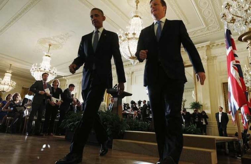 British Prime Minister David Cameron (R) and US President Barack Obama leave a news conference at the White House (photo credit: REUTERS)