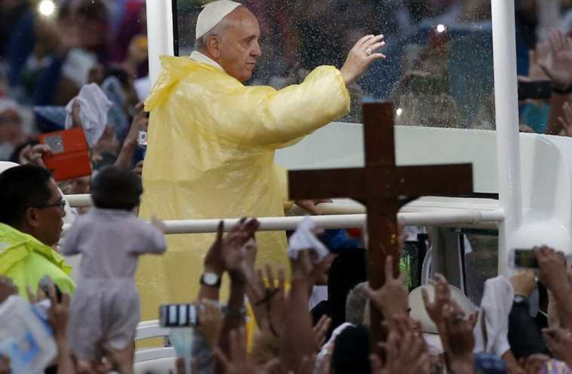 Pope Francis waves from the popemobile after leading a Mass at Rizal Park in Manila (photo credit: REUTERS)