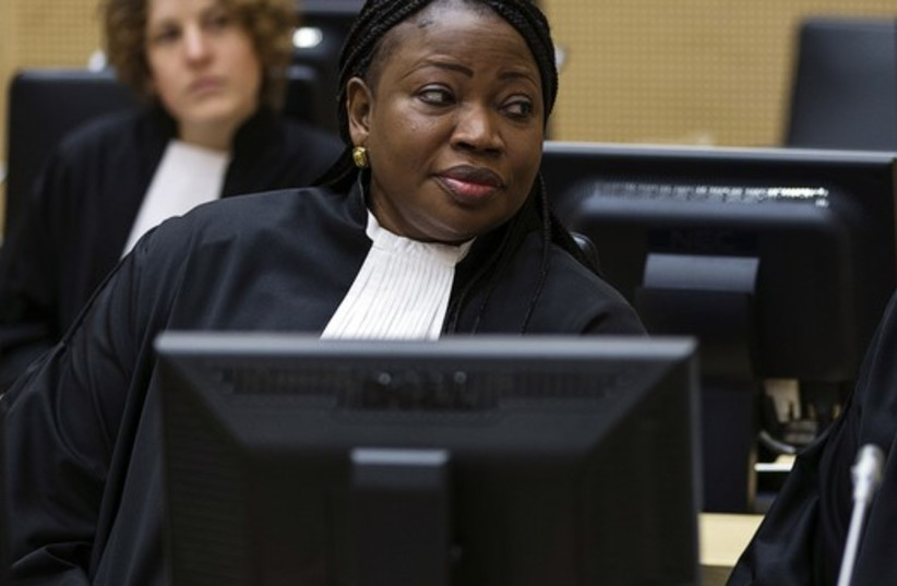 International Criminal Court prosecutor Fatou Bensouda speaks with her deputy, James Stewart, at an ICC hearing in March 2014 (photo credit: REUTERS)