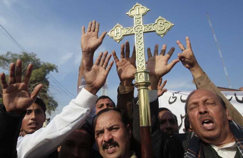 Pakistan's Christian community protest against satirical French weekly Charlie Hebdo, which featured a cartoon of the Prophet Mohammad as the cover of its first edition since an attack by Islamist gunmen, in Peshawar. (photo credit: REUTERS)