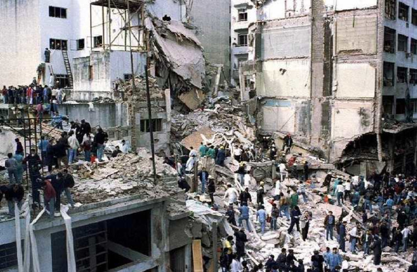 Rescue workers search for survivors and victims in the rubble left after a powerful car bomb destroyed the Buenos Aires headquarters of the Argentine Israeli Mutual Association (AMIA), in this July 18, 1994 file photo (photo credit: REUTERS)