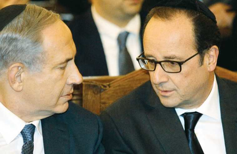 PM Benjamin Netanyahu and French President Francois Hollande speak at the Grand Synagogue in Paris. (photo credit: REUTERS)