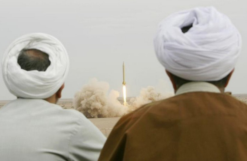 Iranian clerics watch the firing of a Shahab-3 missile during a war game in a desert near the city of Qom (photo credit: REUTERS)