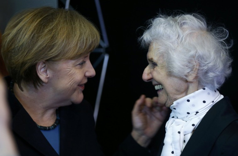 German Chancellor Merkel and Auschwitz survivor Fahidi attend the opening event for the international remembrance of the 70th anniversary of the Liberation of Auschwitz in Berlin. (photo credit: REUTERS)