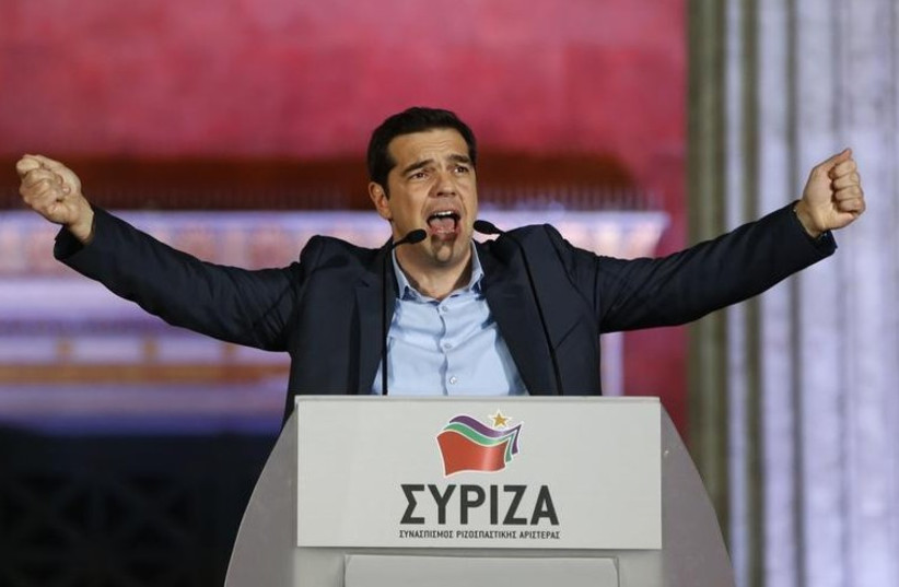 The head of radical leftist Syriza party Alexis Tsipras speaks to supporters after winning the elections in Athens (photo credit: REUTERS)