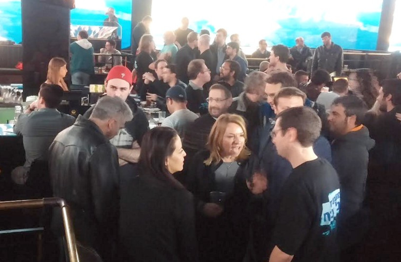 Yair Lapid, with his back turned (left) and Dov Lipman in a crowd of people at the Super Bowl event in Tel Aviv (photo credit: DAVID BRINN)