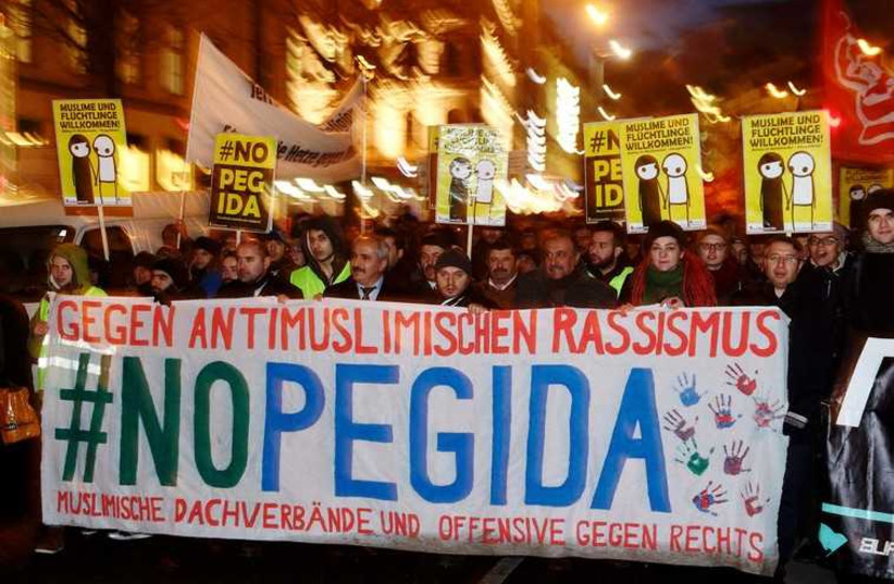 Supporters of the movement of Patriotic Europeans Against the Islamisation of the West (PEGIDA) gather during a demonstration in Vienna (photo credit: REUTERS)