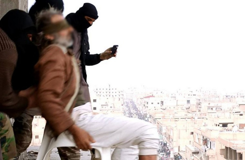 Masked Islamic State terrorists throw man accused of being gay off of a high-rise building (photo credit: Courtesy)