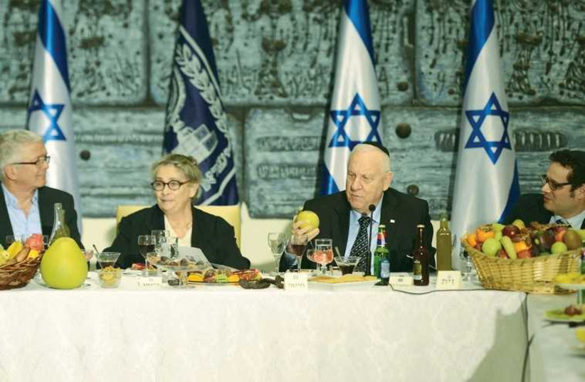 PRESIDENT REUVEN RIVLIN and his wife, Nechama, take part in a Tu Bishvat Seder at their residence in Jerusalem  (photo credit: Mark Neiman/GPO)