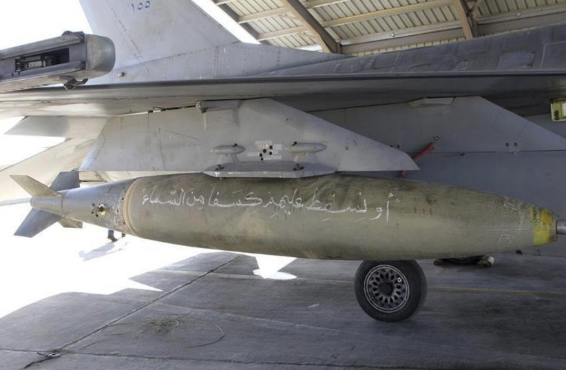A bomb with Koranic verses is pictured on a Royal Jordanian Air Force plane at an air base before it's launch to strike the Islamic State in the Syrian city of Raqqa (photo credit: REUTERS)