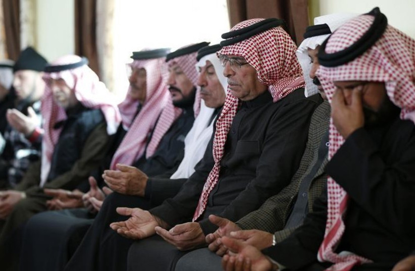 Saif al-Kasaesbeh (3rd R), father of Jordanian pilot Muath al-Kasaesbeh, prays at the family's clan