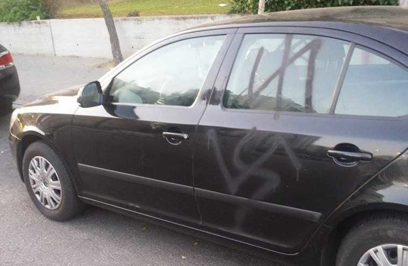 Alexey Ostapenko's car, vandalized with  swastikas and the logo of the Ukrainian Azov battalion  (photo credit: ALEXEY OSTAPENKO)
