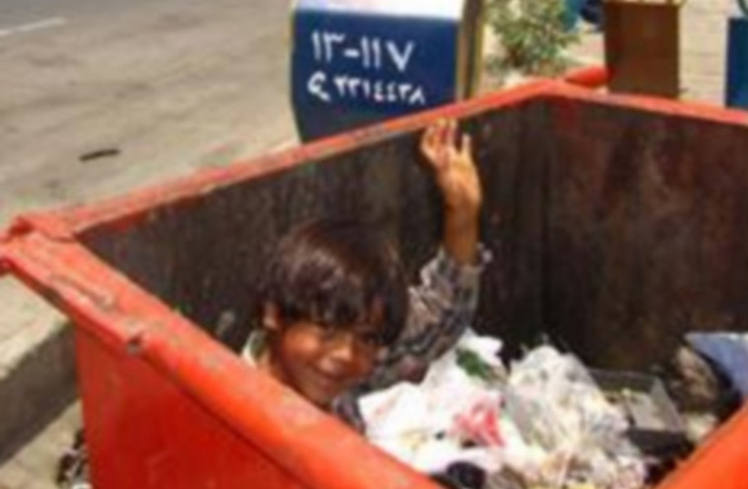 Child in trash (photo credit: IRANIAN MEDIA)