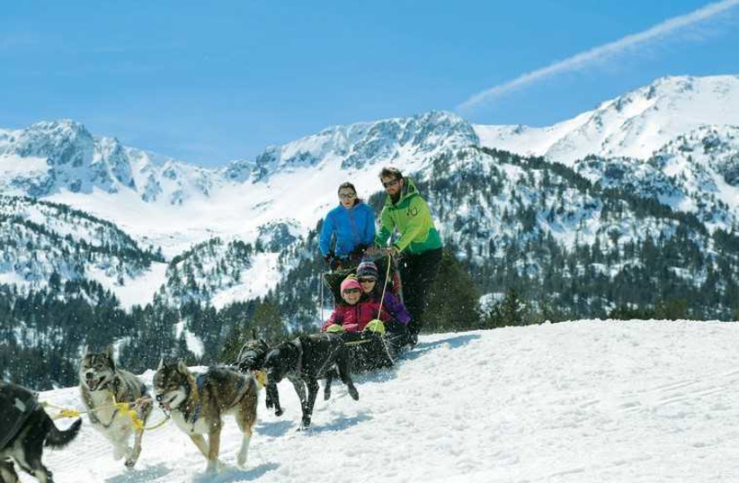 People dogsledding at the Grandvalira ski resort in the Pyrenees Mountains. (photo credit: ANDORRA TOURISM OFFICE)