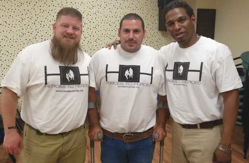 IN TEL AVIV yesterday are, from left, former US soldier Corey Gibson, former IDF border policeman Moti Elmaliach and former US soldier Harrison Manyoma. (photo credit: YAAKOV LAPPIN)