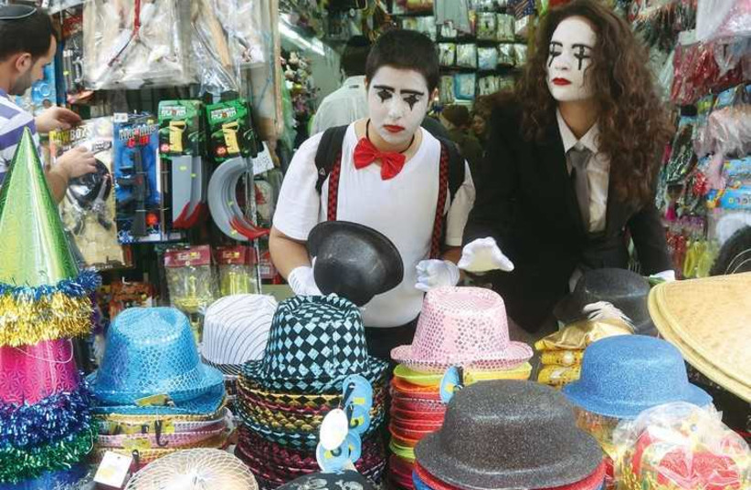 YOUNGSTERS BROWSE at a costume shop on the capital’s Ben-Yehuda pedestrian mall (photo credit: MARC ISRAEL SELLEM)