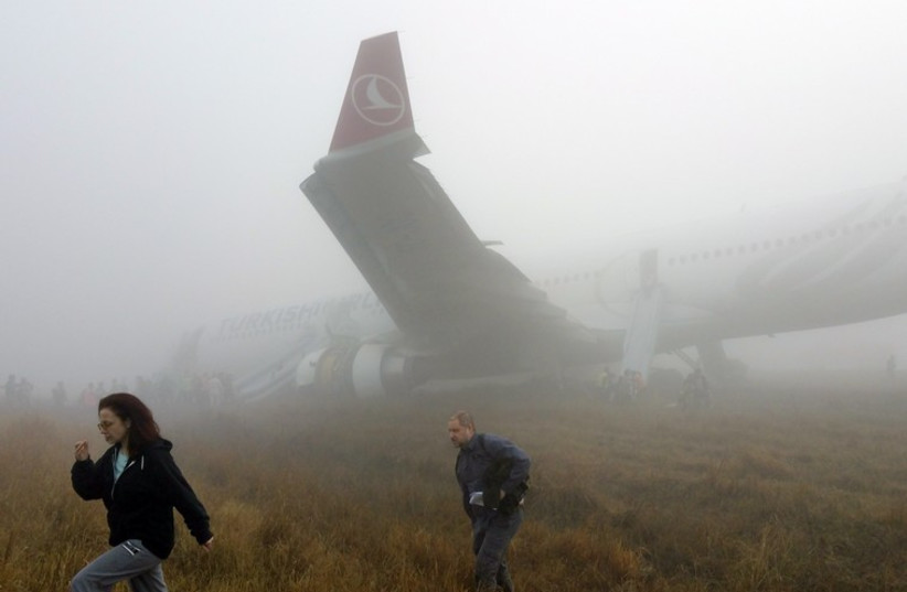 Passengers exit from a Turkish Airlines plane soon after it overshot from the runway in Kathmandu (photo credit: REUTERS)