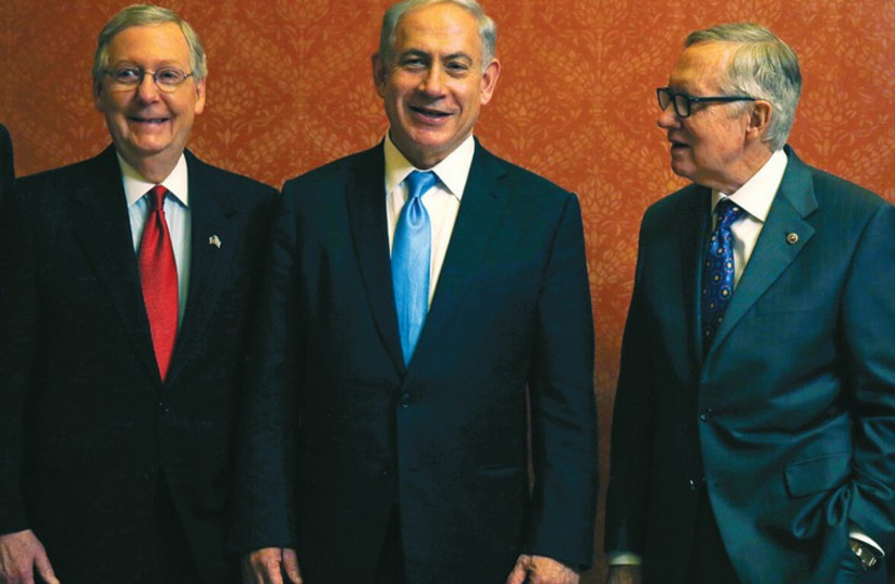 PRIME MINISTER Benjamin Netanyahu meets with US Senate Majority Leader Mitch McConnell (left) and Senate Minority Leader Harry Reid (photo credit: REUTERS)