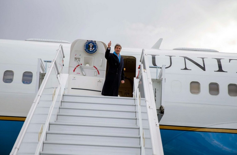 US Secretary of State John Kerry waves as he boards his plane after delivering remarks in Montreux March 4, 2015. (photo credit: REUTERS)