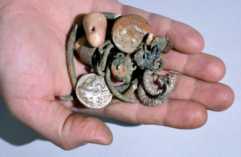 Rare 2,300-year-old silver and bronze coins, jewelry found in ancient northern cave (photo credit: COURTESY OF ISRAEL ANTIQUITIES AUTHORITY)