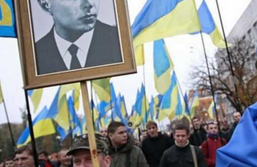 Portrait of UPA leader Stepan Bandera (left) at a rally marking the anniversary of the Ukrainian Insurgent Army (UPA), which fought both Nazi and Soviet forces in World War II [File] (photo credit: REUTERS)