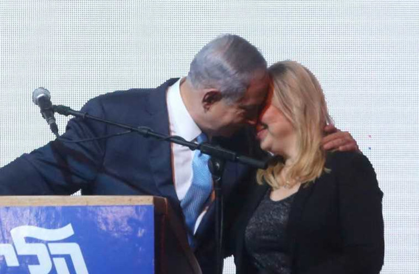 Prime Minister Benjamin Netanyahu (L) shares a moment with his wife, Sara, at Likud headquarters (photo credit: MARC ISRAEL SELLEM)