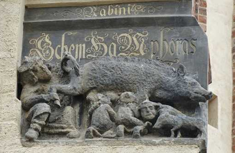 This carving on the facade of Martin Luther’s church in Wittenberg, Germany, shows Jews suckling at a sow’s teat.  (photo credit: JTA)