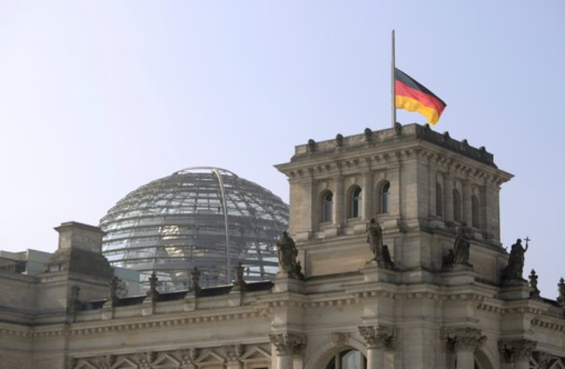 German flag flutters half-mast on top of the Reichstag building, the seat of the German lower house of parliament Bundestag in Berlin, March 25 (photo credit: REUTERS)