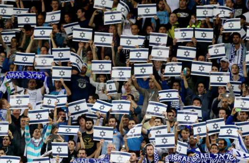 Israel fans hold placards during their Euro 2016 Group B qualifying soccer match against Wales at the Sammy Ofer Stadium in Haifa. (photo credit: REUTERS)