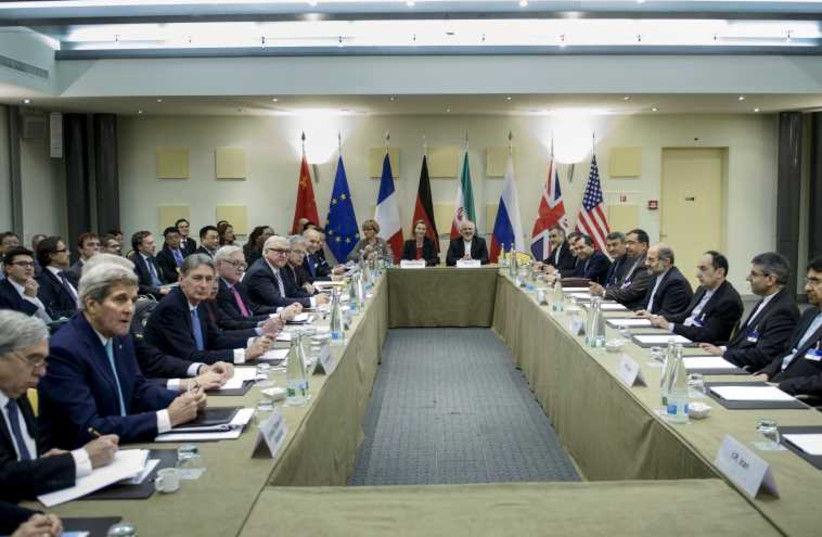 Officials wait for a meeting with officials from P5+1, the European Union and Iran at the Beau Rivage Palace Hotel in Lausanne March 31, 2015. (photo credit: REUTERS)