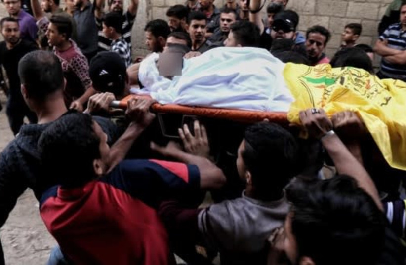 Palestinians attend mass funeral of 27 year old Ahmed Mohammed a-Shakhri, killed during Israeli airstrikes (photo credit: ARAB MEDIA)