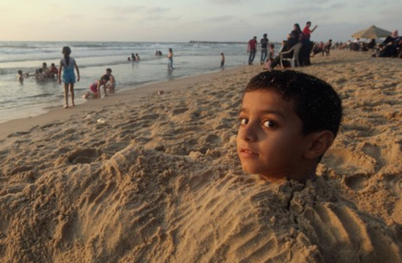 Palestinian boy in sand 465