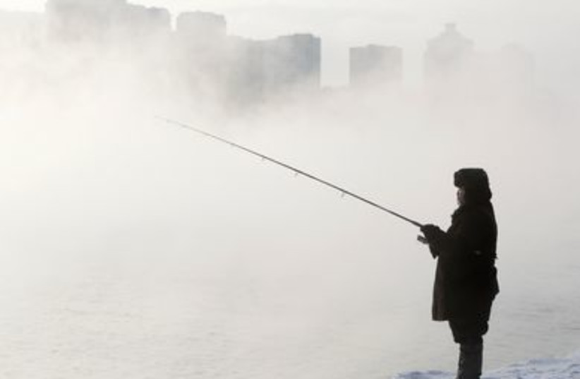Fisherman waits for a catch in the River Moscow