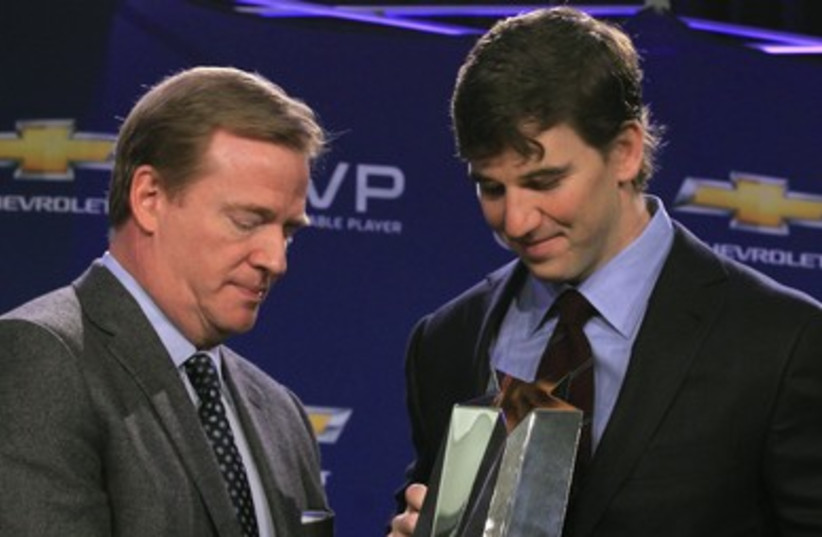 Quarterback Manning receivesMost Valuable Player trophy 