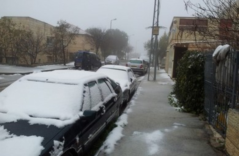 Cars loaded with snow in Kiryat Arba